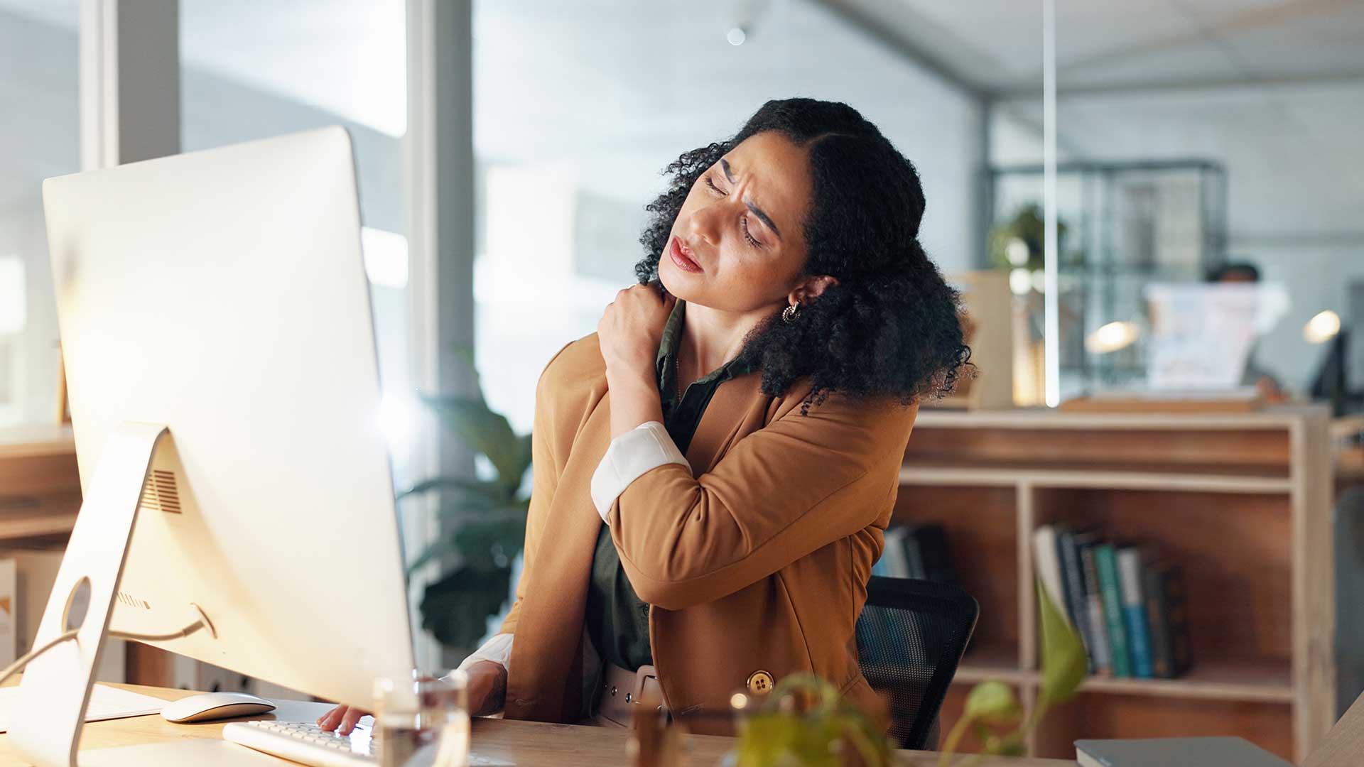 Lady with sore neck working at her desk